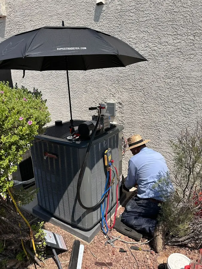 HVAC technician performing outdoor AC maintenance in Portland